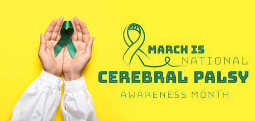 Hands with green ribbon on yellow background. Liver cancer concept