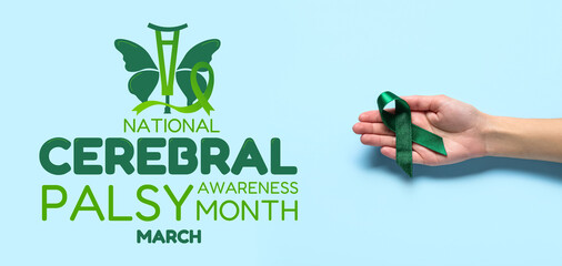 Hand with green ribbon on light blue background. Liver cancer concept