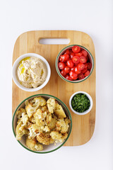 Roast cauliflower tomatoes and hummus salad