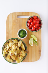 Roast cauliflower tomatoes and hummus salad