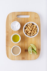 Hummus ingredients on a wood cutting board