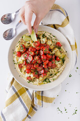 Roast cauliflower tomatoes and hummus salad