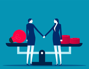 Two business person shake hands to make a deal on the background of scales