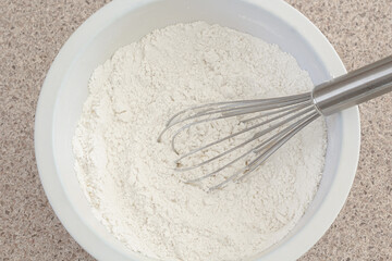 Flour and whisk in mixing bowl