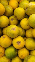 Close up pile of tasty fresh oranges sold at the market as a background.