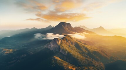 Fototapeta premium Sunshine on a mountain range from a birds perspective