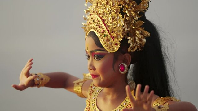 authentic balinese dancer dancing with dramatic facial expression, bali tourism