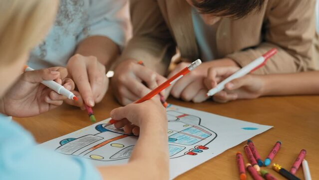 Closeup of diverse student and teacher hands write or draw picture. Mentor and multicultural children do activity together with colored pencils, markers and crayons. Creativity workshop. Erudition.