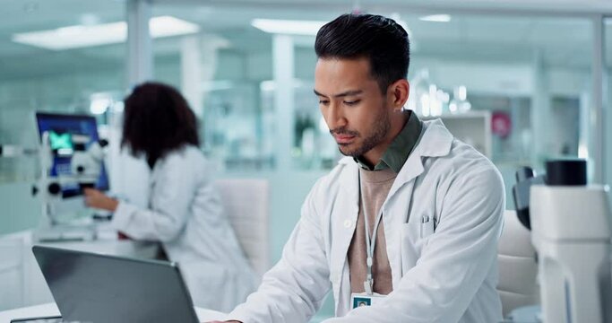 Scientist, thinking on computer and tablet for laboratory research, DNA analysis and results in medical study at night. Young man of science and biotechnology, digital software or laptop for solution