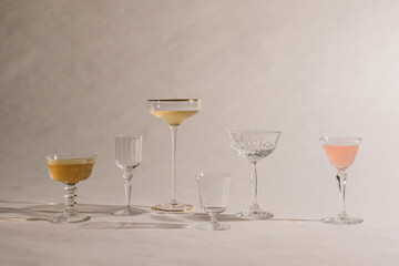 collection of assorted cocktail glasses on white 