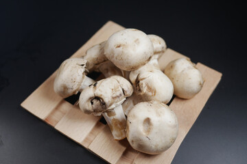 Fresh champignons mushroom in a white bowl on table 