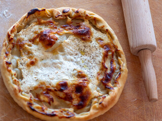 Homemade Cheese Pie on Wooden Surface with Rolling Pin