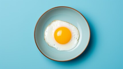 Minimalist Egg yolk in blue frying pan 