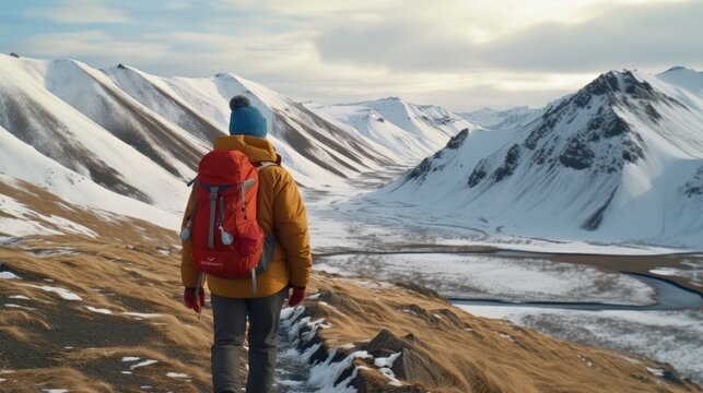 Winter hike on snow mountain happy hiker man walking in ice wilderness in Iceland . Europe travel adventure trek in nature landscape.