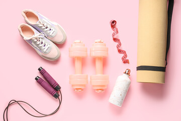 Composition with sports equipment and shoes on pink background