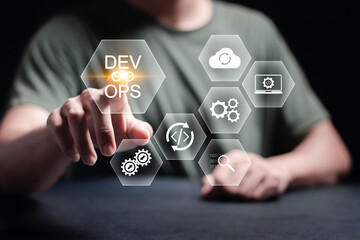 DevOps software development concept. IT operations, high software quality and software development. Agile programming development. Person touching DevOps icon on virtual screen.
