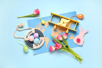 Composition with toy plane, world map, Easter eggs and tulips on color background