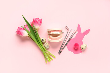 Composition with dentist's tools, tulip flowers and Easter decor on pink background