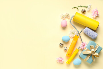 Composition with paint rollers, gift box, flowers and Easter eggs on color background