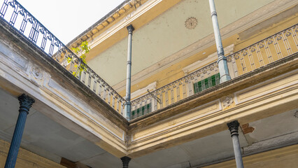 An old colonial house in Buenos Aires. A fragment. Open terraces with lattice railings and columns...