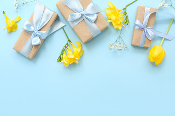 Cute wrapped gift boxes and flowers on cyan background