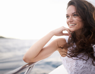 Woman, water and smile on yacht in outdoors, happy and travel to ocean on summer holiday. Female person, cruise and relax on boat transportation in sea, tranquil and sailing in Italy on vacation