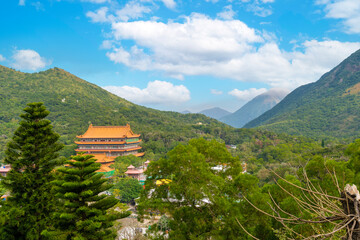 Top view of Po Lin temple (Precious Lotus) or Po Lin Monastery with green mountains and blue sky. View from above of the Big Buddha, Hong Kong.