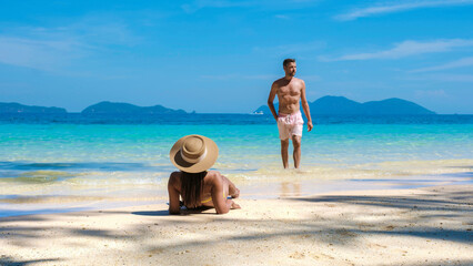 Koh Wai Island Trat Thailand is a tinny tropical Island near Koh Chang. a young couple of men and women on a tropical beach lying down sunbathing during a luxury vacation in Thailand © Fokke Baarssen