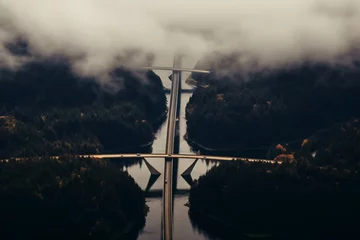 Foto op Canvas aerial photo of a bridge crossing a river © alisaaa
