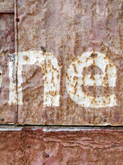 Rusty metal surface with peeling white pain