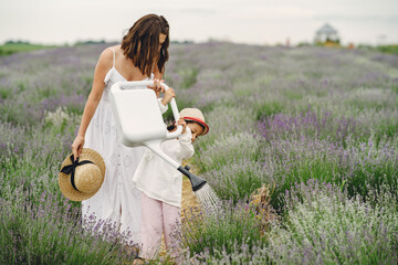 Little girl with her mother in a lavender field