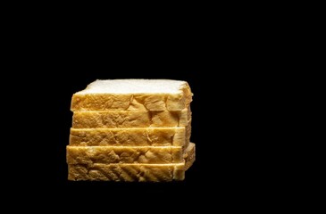 Closeup of Bread Pieces Pile Isolated on Black Background with Copy Space