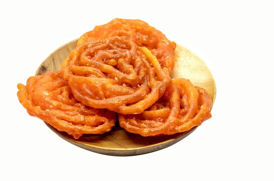 Jalebi or Jilapi in Wooden Bowl Isolated on White Background with Copy Space, Also Known as Zalabia or Mushabak