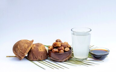 Khejur Ras or Date Palm Jaggery, Phoenix Dactylifera Fruit and Date Palm Tree Juice Isolate on White Background with Copy Space, Also Known as Date Palm Sap or Khejur Rosh