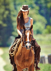 Woman, cowgirl and horse riding in the countryside for journey, travel or outdoor adventure in...
