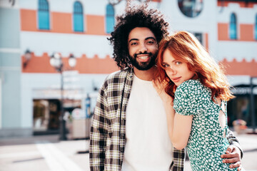 Smiling beautiful redhead  woman and her handsome boyfriend. Model in casual summer clothes. Happy...