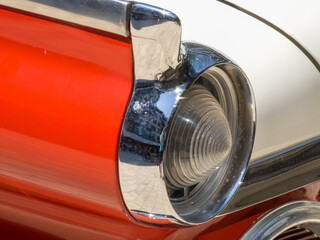 Classic vintage car - tail lights with fins on a red and white vintage old American vehicle.