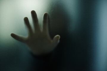 Scary, hand and person on glass with mystery in window or trapped in home. Ghost, shadow and figure...