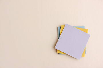 Top view of a blank Sticky Note with space for text on light paper background