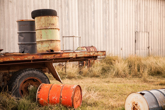 Storage drums lying near shed on farm