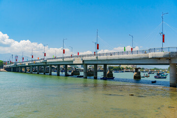 Fototapeta na wymiar The city bridge over the river. The Kai River in Nha Trang in Vietnam. The urban landscape.