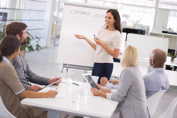 Fototapeta premium Businesswoman, presentation and training meeting with project planning or company vision, growth or coaching. Female person, colleagues and tablet or brainstorming for proposal, future or startup