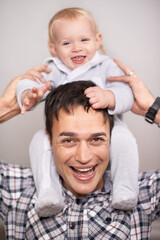 Fototapeta na wymiar Love, portrait or father and baby with piggyback, playing or bonding at home with shoulder games. Child development, learning and face of dad with girl having fun, support and laughing in family time