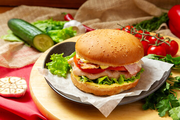 Burger, Sandwich with chicken breast, bacon, cheese and sauce. Fast food.