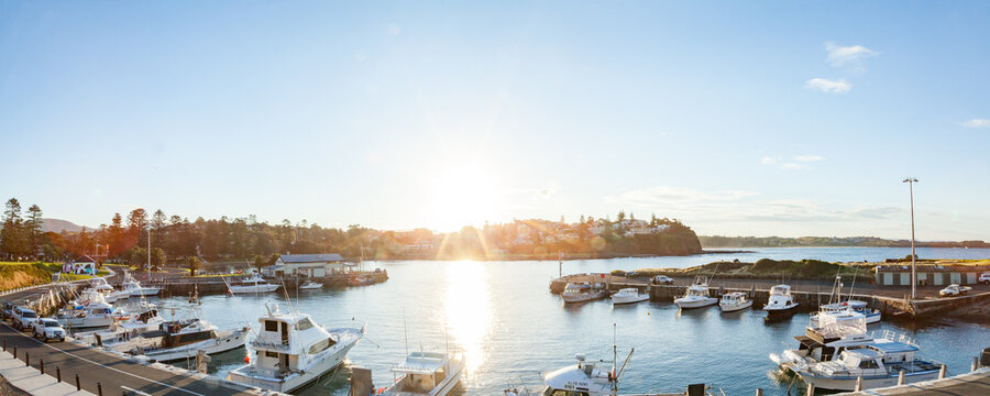 Boats Docked In A Harbour In Kiama With Lens Flare At Sunset