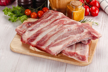 Raw pork ribs over board