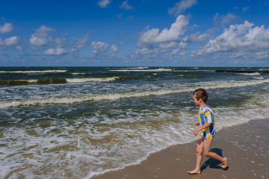 Happy kid boy at the summer beach