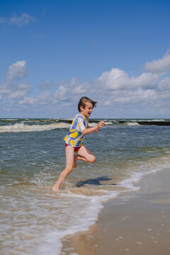 Happy kid boy at the summer beach