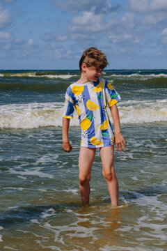 Happy kid boy at the summer beach