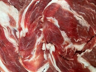 sliced red raw beef meats which show its beautiful white fat lines in a full frame shot, using as background